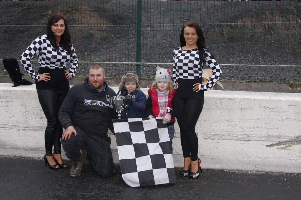 Birches man Dave Haugh celebrates his win in the Big Van Bangers at Tullyroan Oval with Callum and Jessica Doak from sponsors Cirrus Plastics.