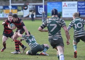 Armagh's Matthew Hookes slips through a Greystones's Tackle to score the final try of the game