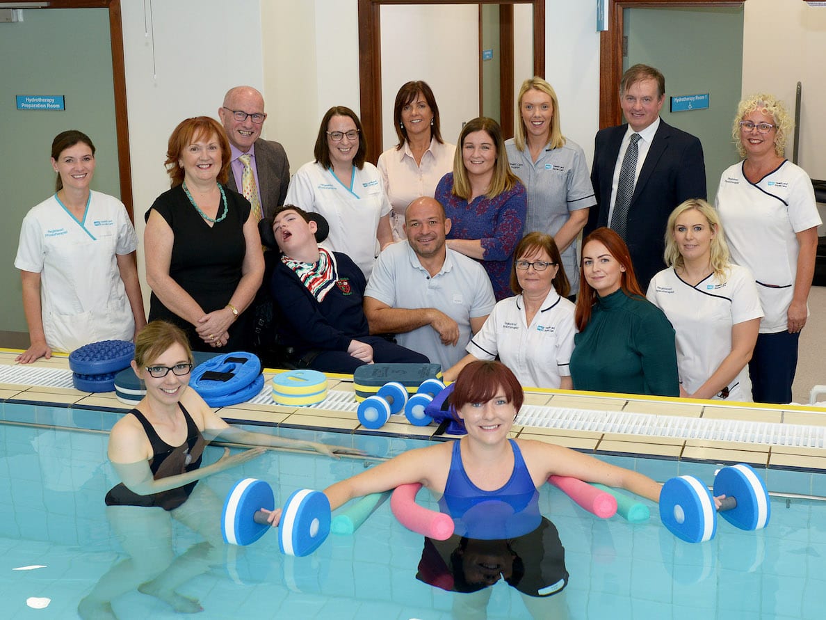 Special guests Patient, Odhran Smyth and Rory Best, OBE, Irish Rugby Union player and captain of Ireland's International team with Odhran’s mother Patrice; Non Executive Director John Wilkinson; Melanie McClements, Interim Director of Older People and Primary Care; Brian Beattie, Assistant Director of Primary Care; Teresa Ross, Head of Physiotherapy and Physiotherapy staff.