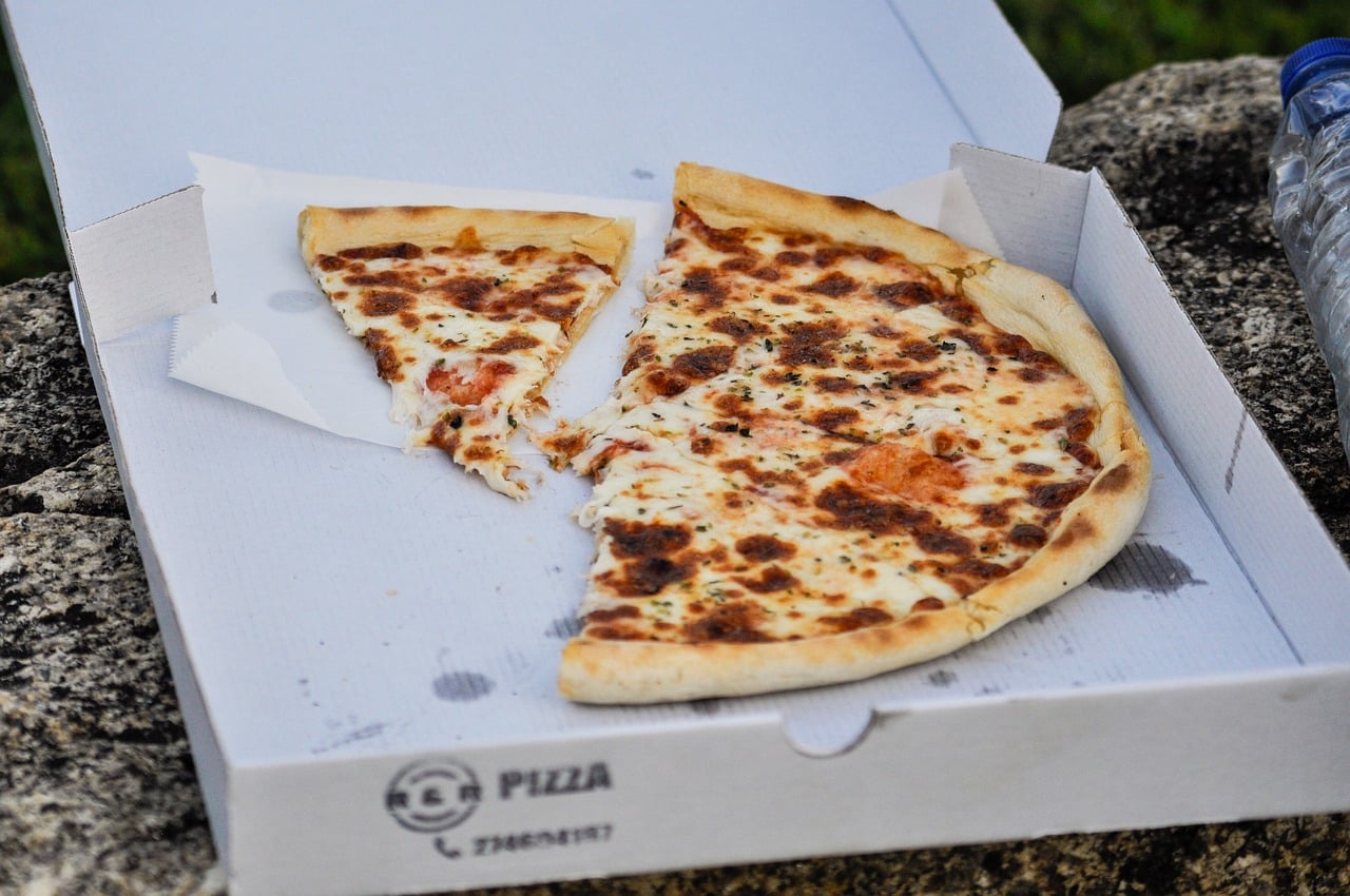 half eaten pizza in a pizza box